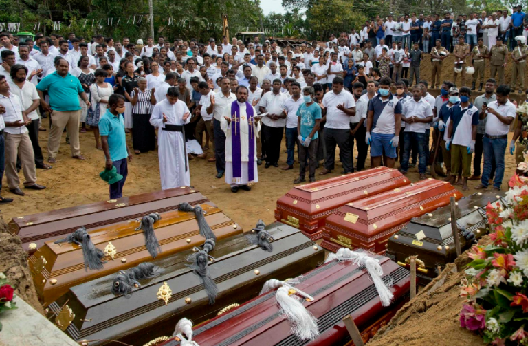 In pictures: Sri Lanka on alert as mourners bury blast victims
